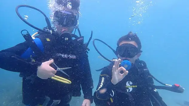 Genç kuaför denizin altında saç kesti